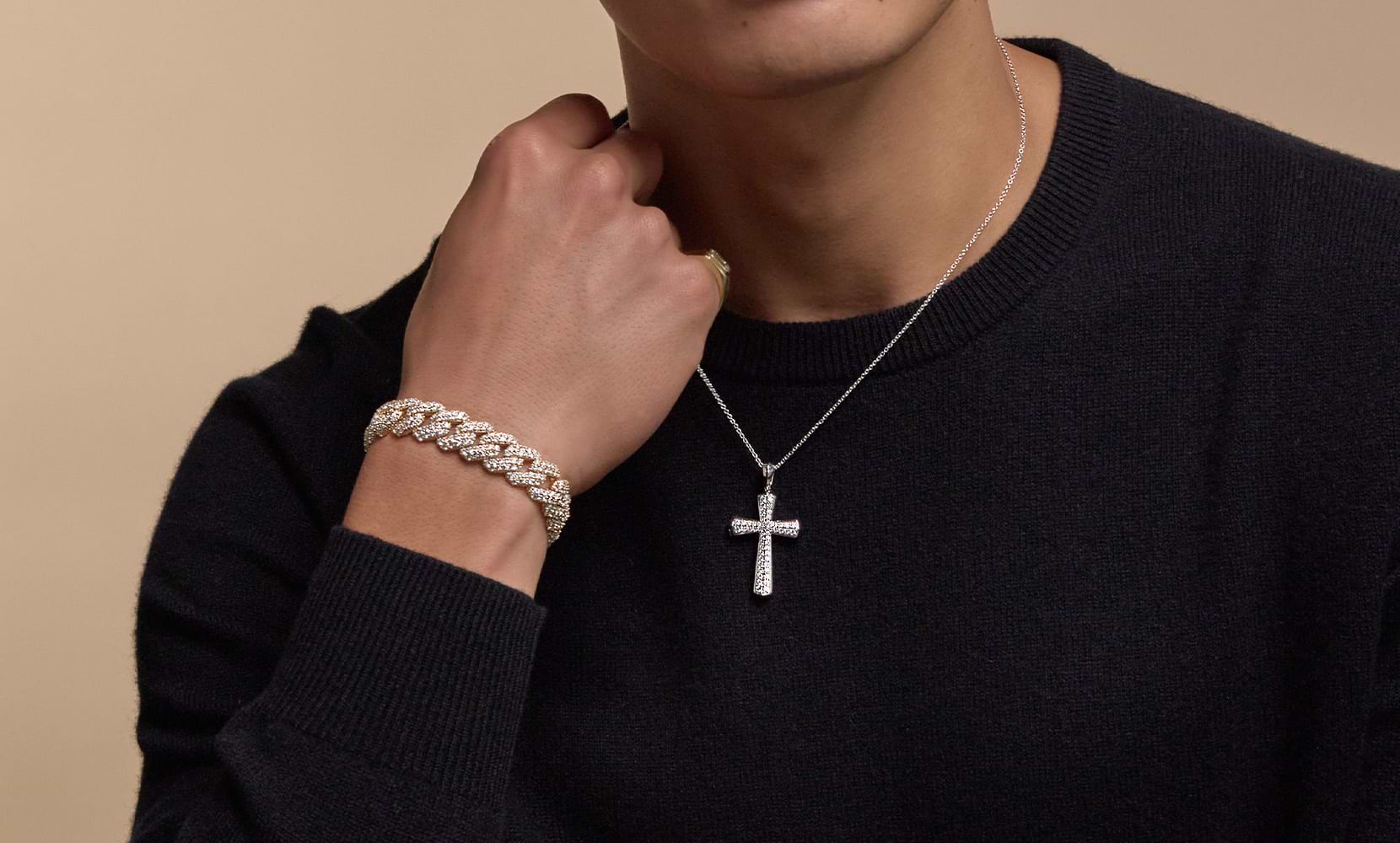 Image of a male model's neck and chest featuring a men's bracelet and a diamond cross necklace