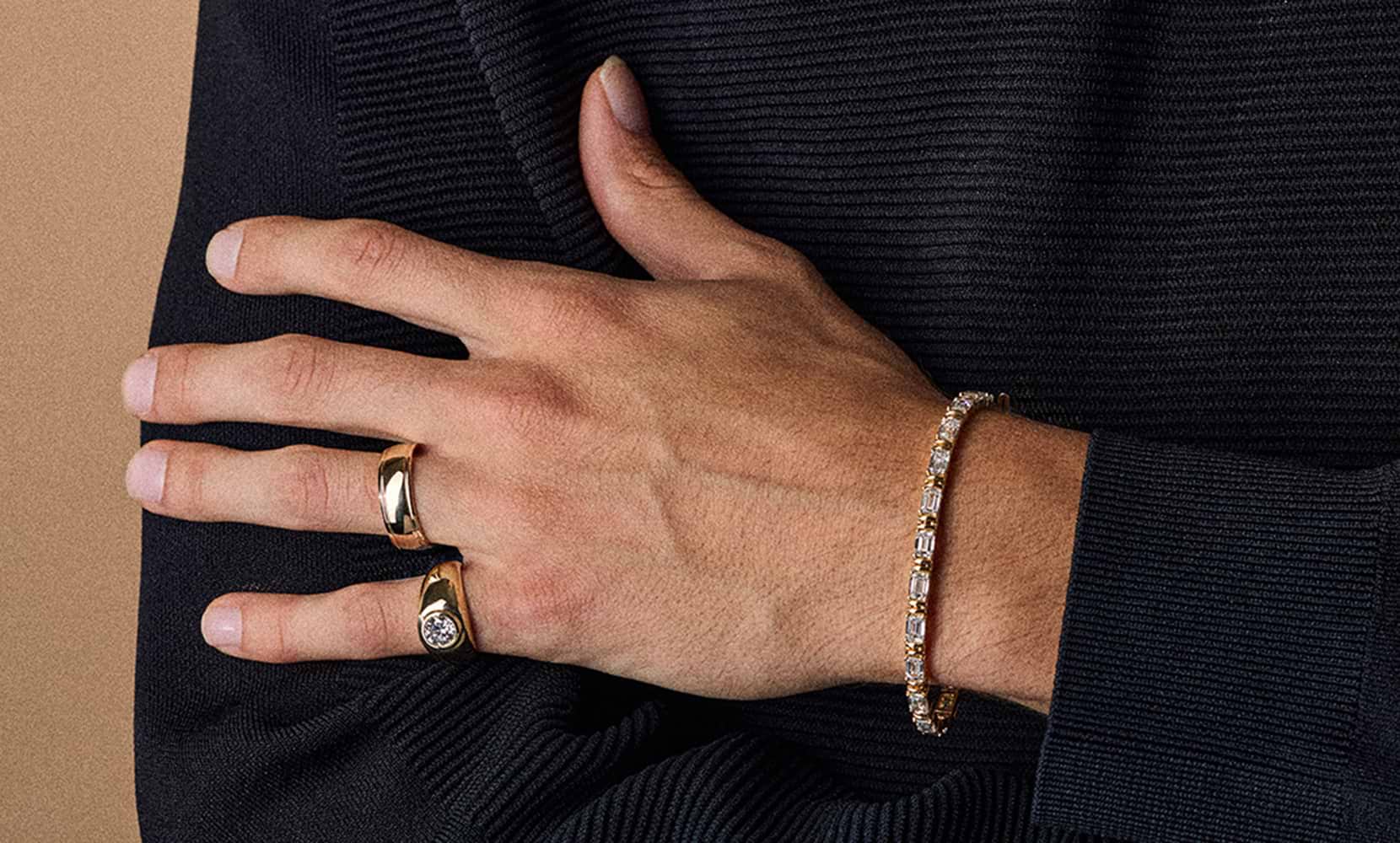 Model wearing Grown Brilliance gold rings and a diamond bracelet.