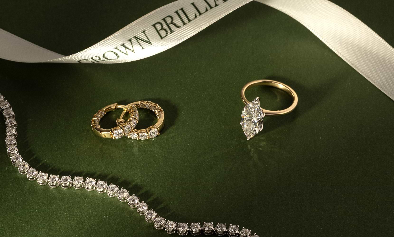 Lab grown diamond ring, hoops, and tennis bracelet by Grown Brilliance.