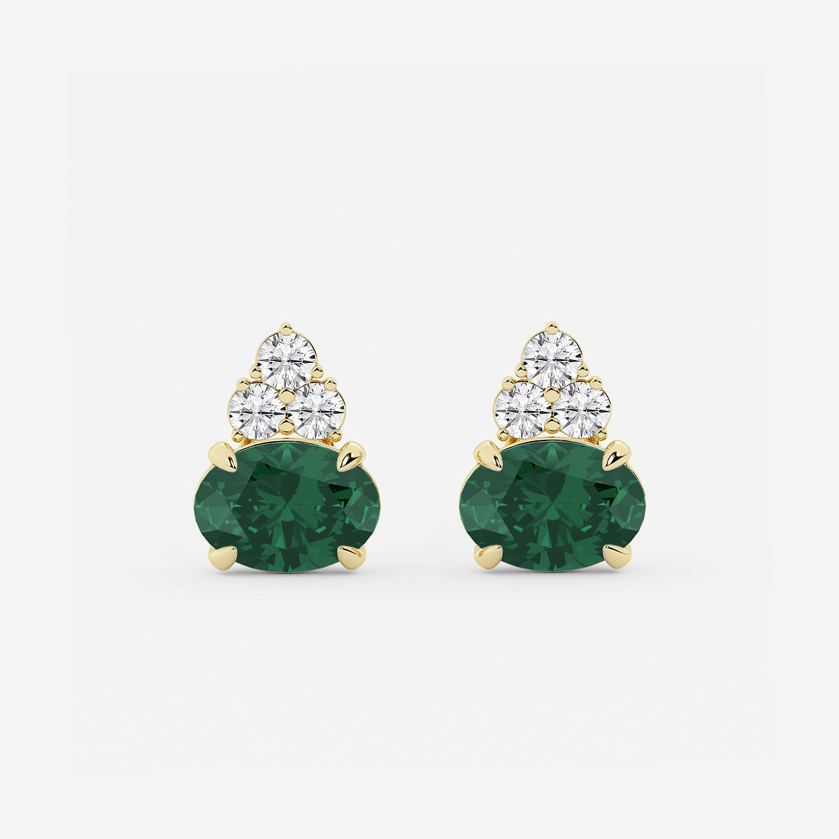 10.7x7.49mm East-West Oval Cut Created Emerald with 3/4 ctw Round Lab Grown Diamond Cluster Earrings