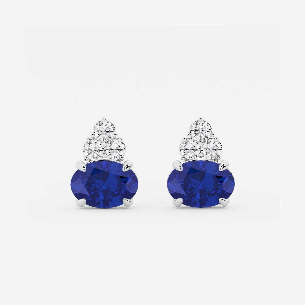 10.7x7.49mm East-West Oval Cut Created Sapphire with 3/4 ctw Round Lab Grown Diamond Cluster Earrings